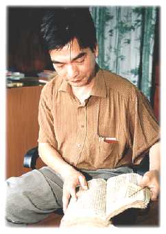 Photo: The Rev Yu Cheng Kun holding one of the few Bibles to survive the Cultural Revolution